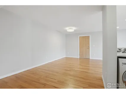 a view of an empty room and wooden floor