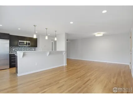 a view of a kitchen with a sink and a large window