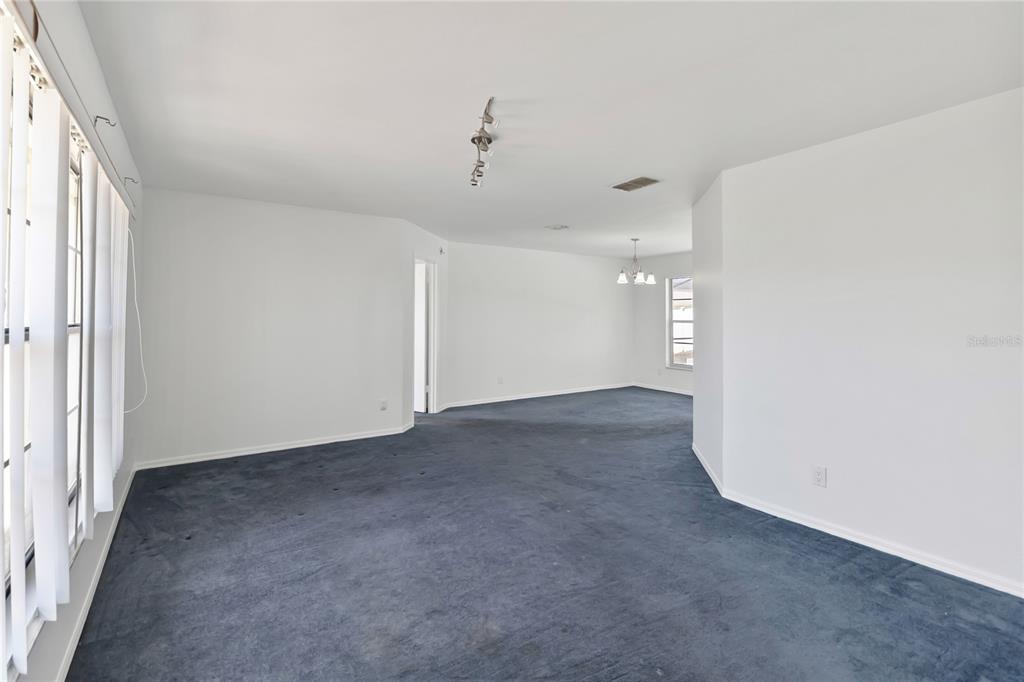 7771 Indian Ridge Trail North Kissimmee, FL 34747 - Photo 8 of 51 a view of a big room with wooden floor and windows