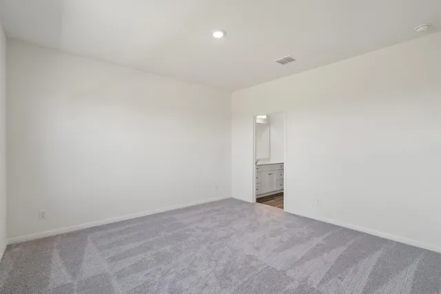 a view of an empty room with a kitchen
