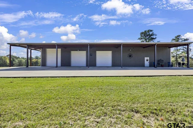 a view of a house with a yard and sitting area