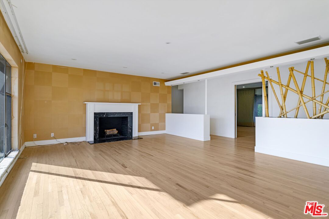 211 Cumberland Road Glendale, CA 91202 - Photo 11 of 48 a view of an empty room with wooden floor and a fireplace