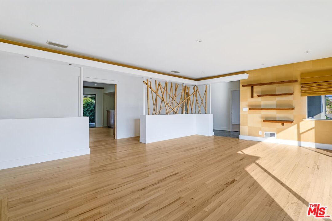 211 Cumberland Road Glendale, CA 91202 - Photo 13 of 48 a view of an empty room with wooden floor and stairs