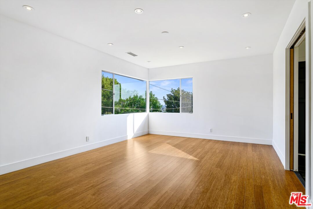 211 Cumberland Road Glendale, CA 91202 - Photo 14 of 48 a view of an empty room with wooden floor and a window