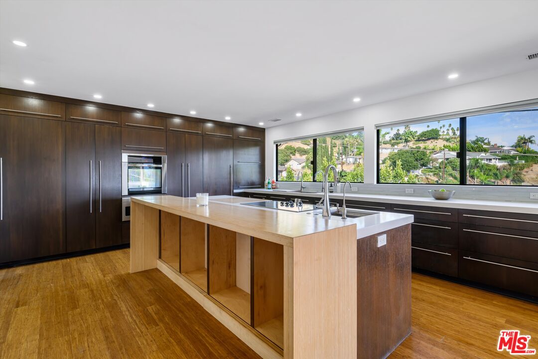 211 Cumberland Road Glendale, CA 91202 - Photo 17 of 48 a large kitchen with stainless steel appliances granite countertop a large counter top and a stove