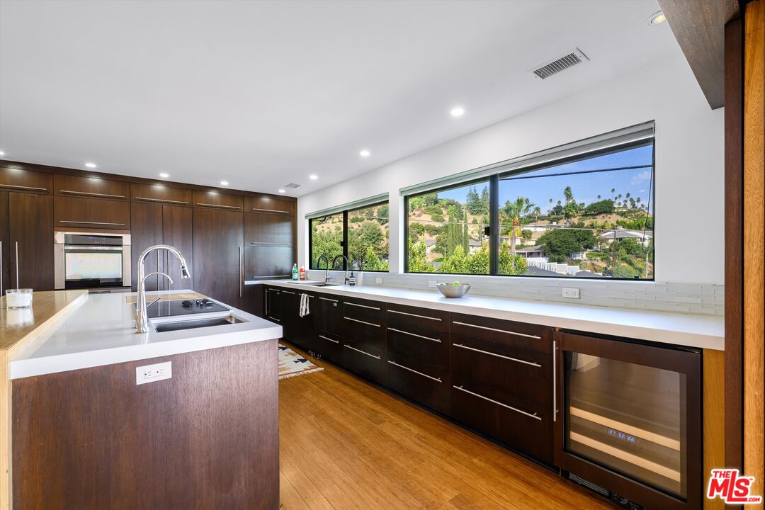 211 Cumberland Road Glendale, CA 91202 - Photo 21 of 48 a kitchen with kitchen island a stove and a sink