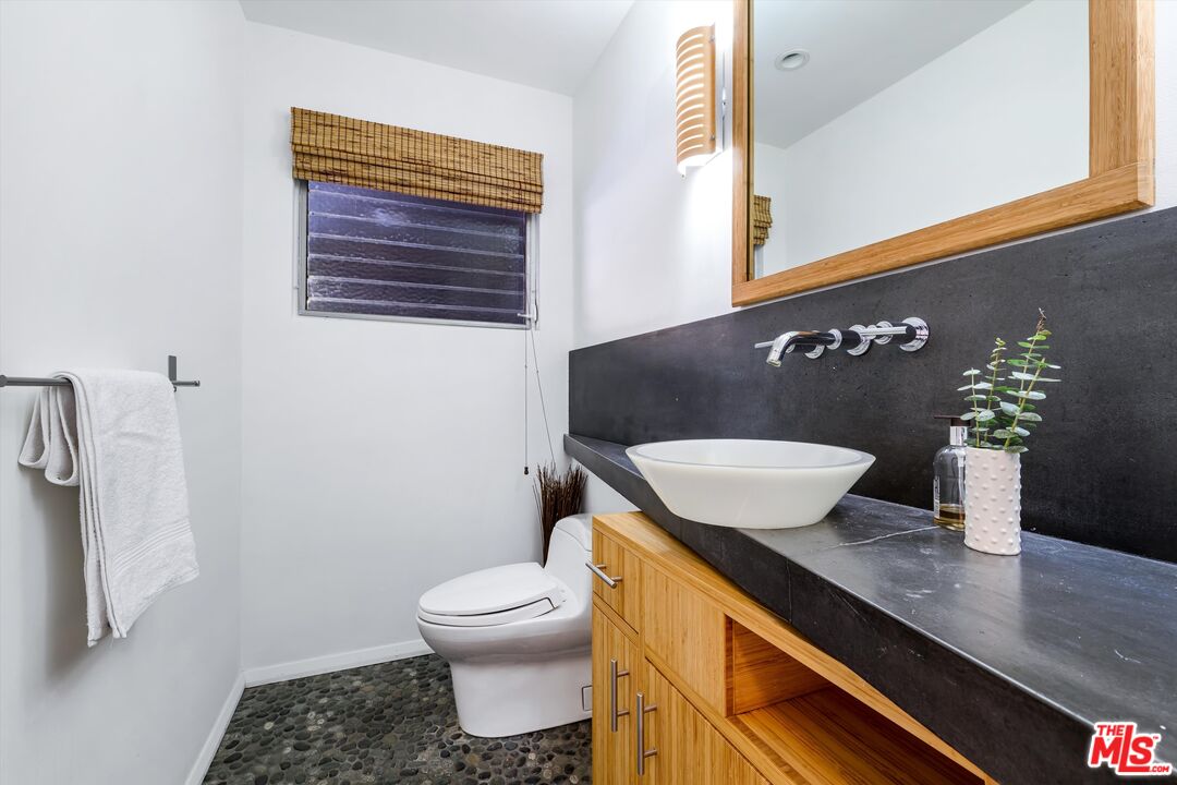211 Cumberland Road Glendale, CA 91202 - Photo 23 of 48 a bathroom with a granite countertop sink and a mirror
