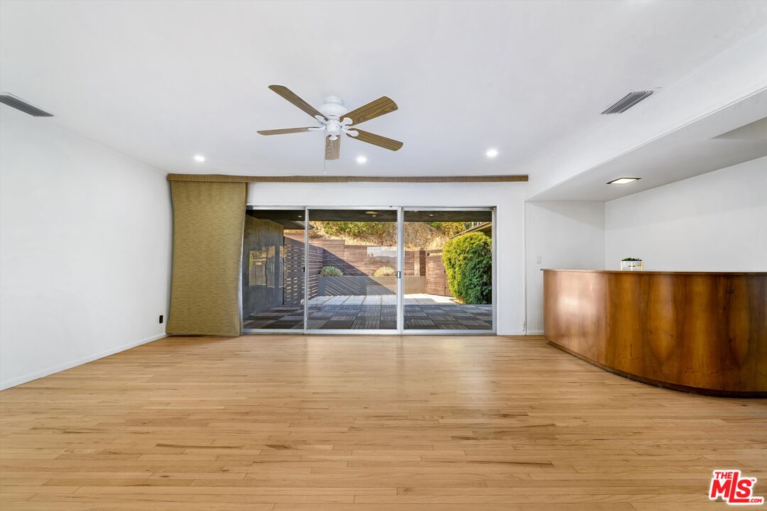 211 Cumberland Road Glendale, CA 91202 - Photo 26 of 48 a view of an empty room with a window and wooden floor