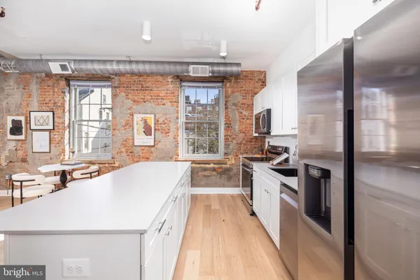 a large white kitchen with a large window