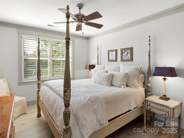 a bedroom with a bed and a lamp