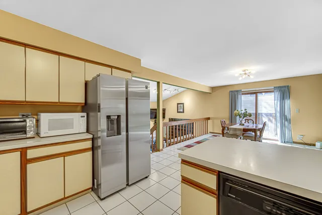 a kitchen with stainless steel appliances a refrigerator sink and stove
