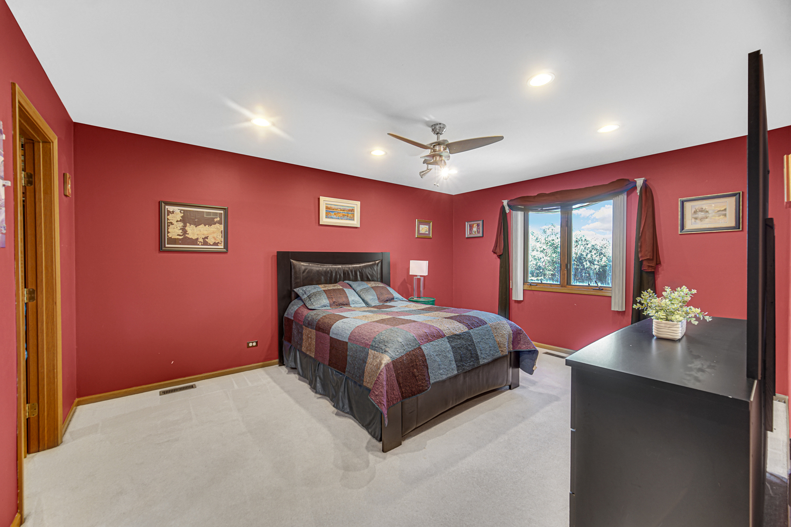 316 Morningside Drive, Unit A Bloomingdale, IL 60108 - Photo 16 of 35 a spacious bedroom with a bed and a chandelier