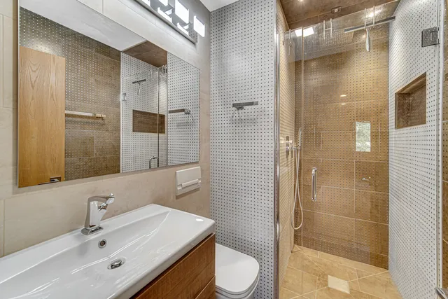 a bathroom with a sink toilet and shower