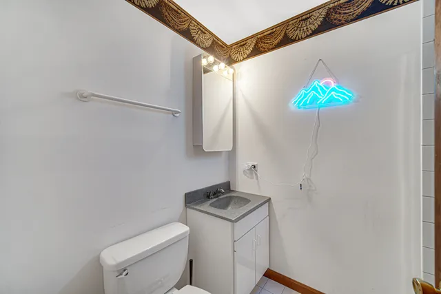 a bathroom with a toilet a sink and a shower curtain