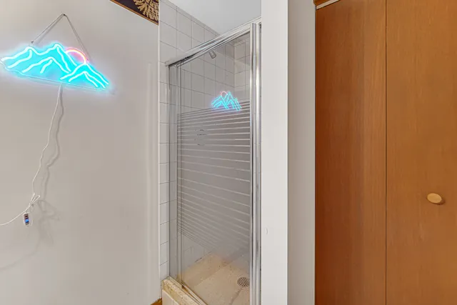 a bathroom with a small walk in closet and a window