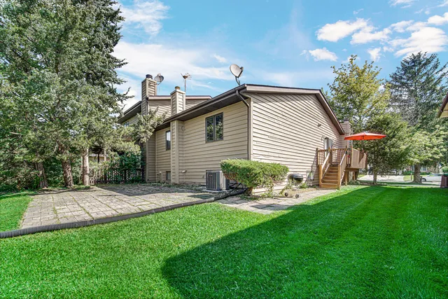 a backyard of a house with table and chairs