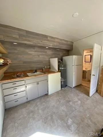 a view of a kitchen with refrigerator and microwave
