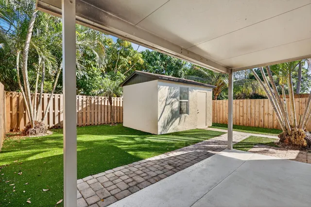 an aerial view of residential house with outdoor space and trees