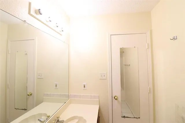 a bathroom with a tub shower and sink