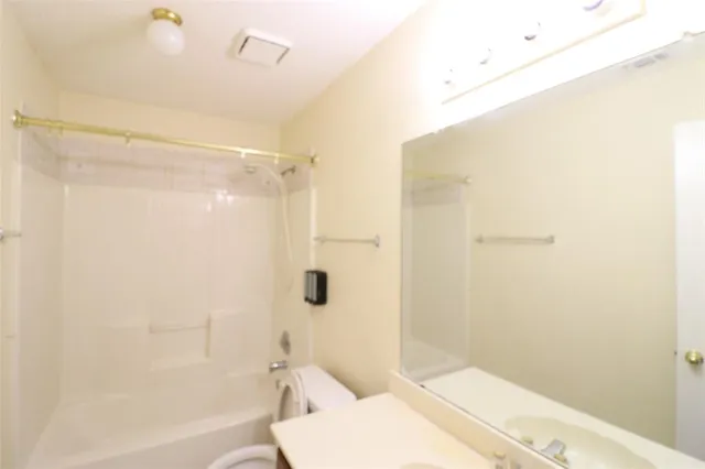 a bathroom with a shower and a toilet