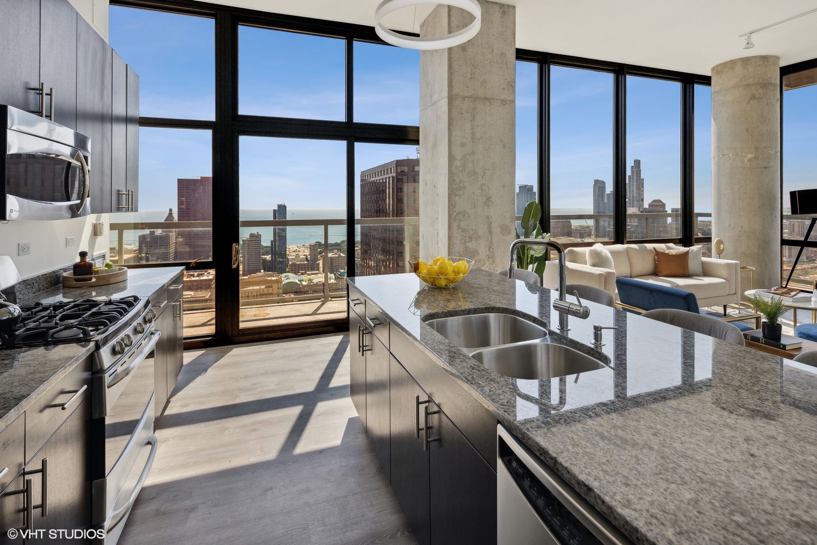235 West Van Buren Street, Unit 4602 Chicago, IL 60607 - Photo 8 of 25 a kitchen with granite countertop a sink and a stove