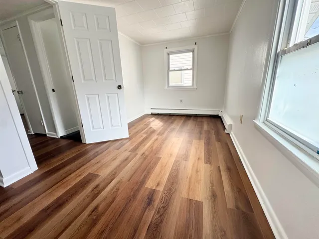 a view of a room with wooden floor and fence
