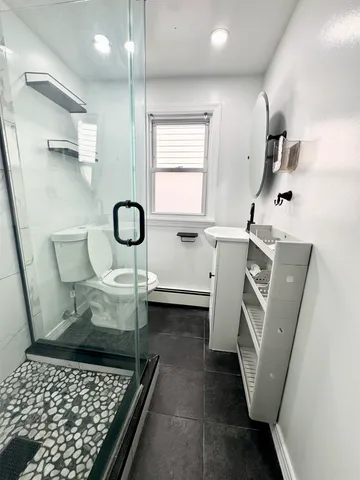 a bathroom with a sink toilet and mirror