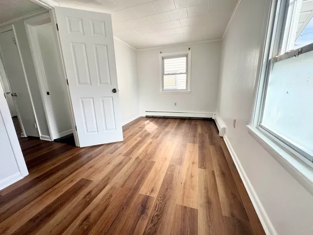 a view of a room with wooden floor and staircase