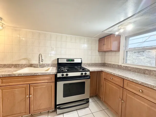 a kitchen with granite countertop white cabinets and appliances