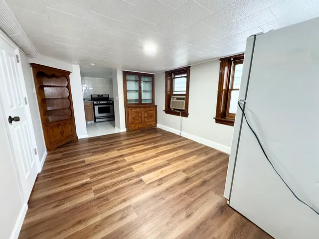 a spacious bedroom with a bed and a flat screen tv