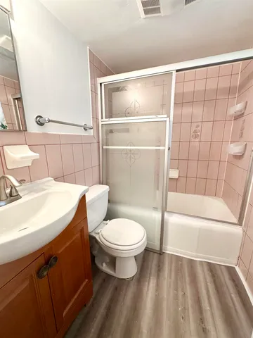 a bathroom with a sink toilet and shower