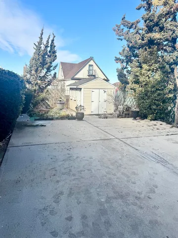 a view of large house with a yard and large tree