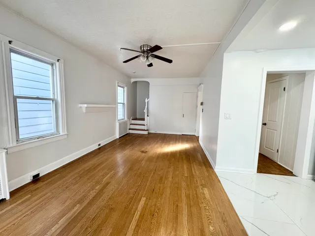 a view of a room with wooden floor and staircase