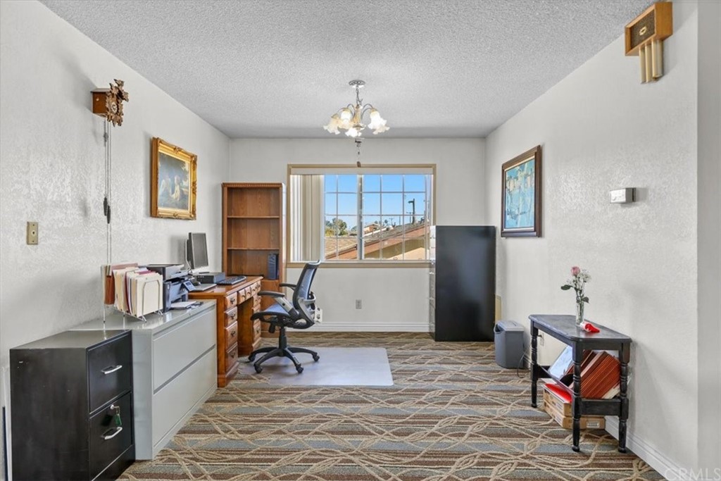302 East 213th Street Carson, CA 90745 - Photo 17 of 41 a view of a workspace with furniture and a window