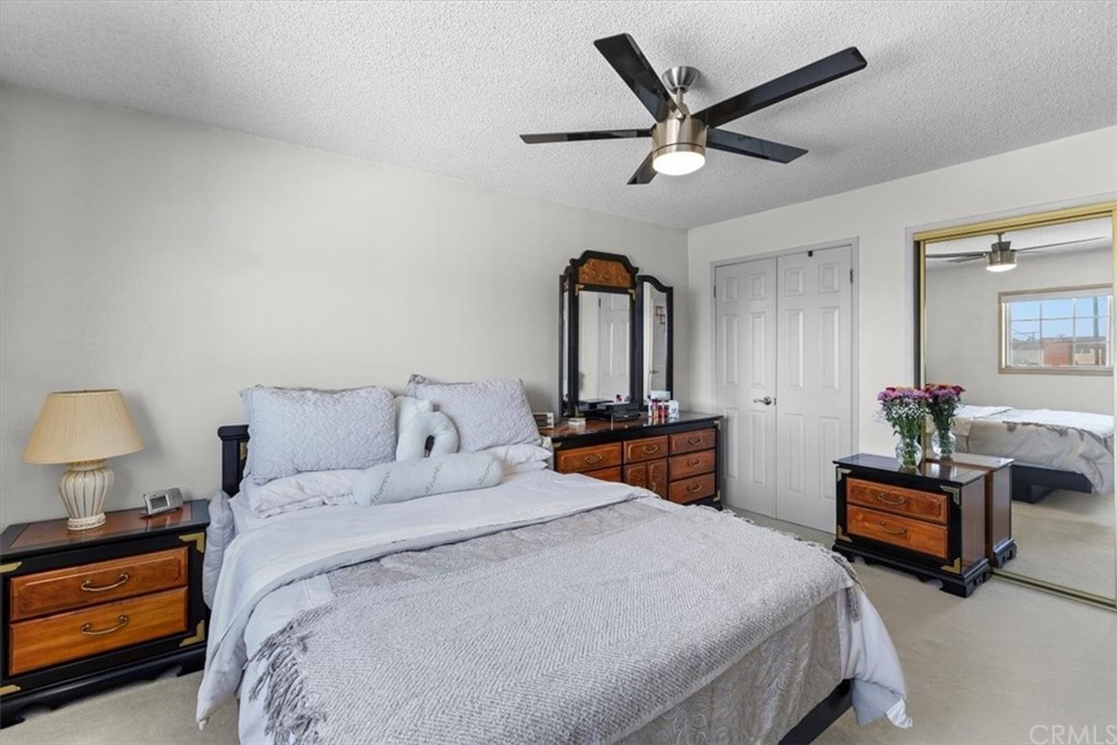 302 East 213th Street Carson, CA 90745 - Photo 20 of 41 a bedroom with bed and a chandelier