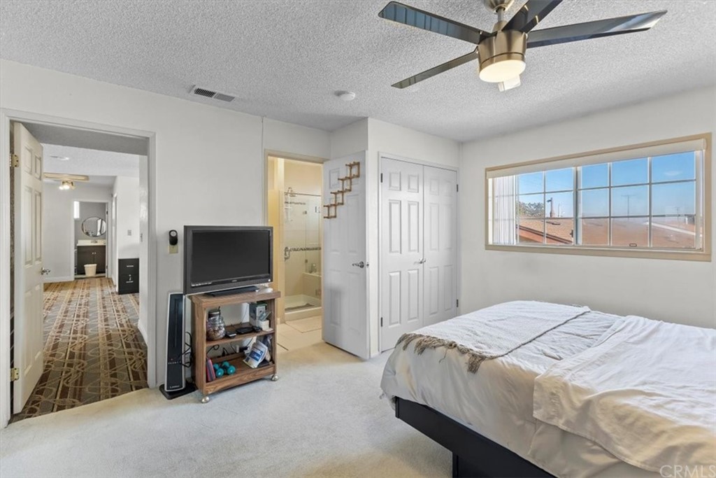 302 East 213th Street Carson, CA 90745 - Photo 21 of 41 a bedroom with a bed and a flat screen tv