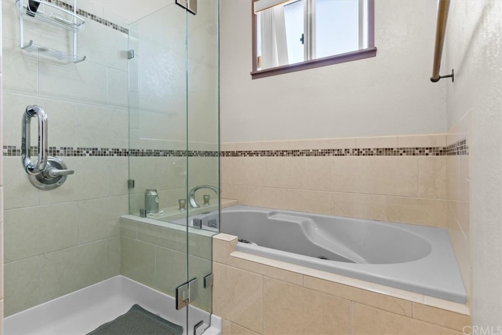 302 East 213th Street Carson, CA 90745 - Photo 23 of 41 a bath tub sitting next to a white sink and vanity