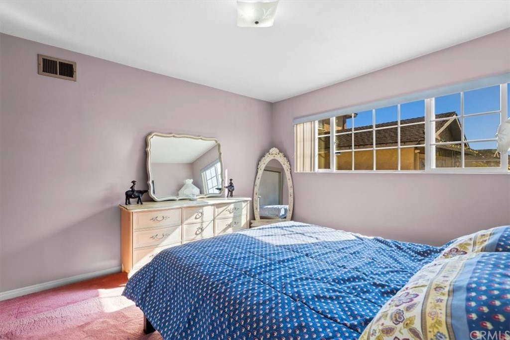 302 East 213th Street Carson, CA 90745 - Photo 29 of 41 a bedroom with a bed wooden floor and window