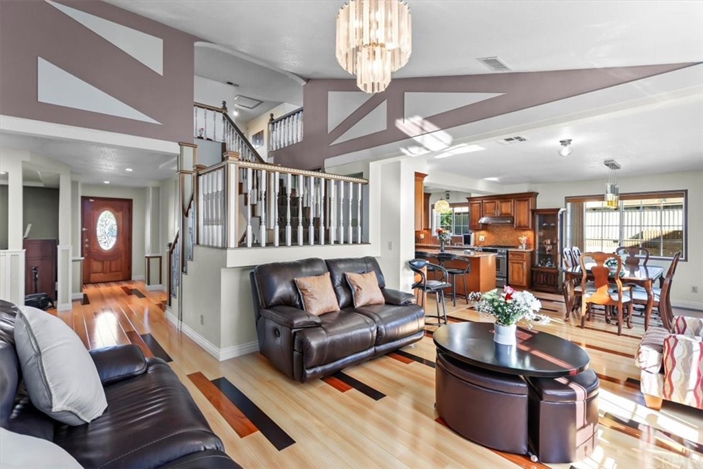 302 East 213th Street Carson, CA 90745 - Photo 3 of 41 a living room with furniture a chandelier and a dining table view