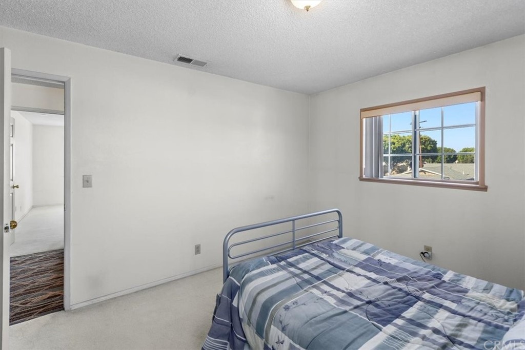302 East 213th Street Carson, CA 90745 - Photo 33 of 41 a bedroom with a bed and a window