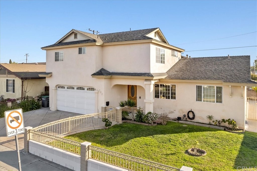 302 East 213th Street Carson, CA 90745 - Photo 40 of 41 a front view of house with yard