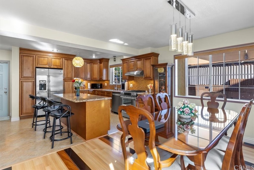 302 East 213th Street Carson, CA 90745 - Photo 6 of 41 a kitchen with a table and chairs in it