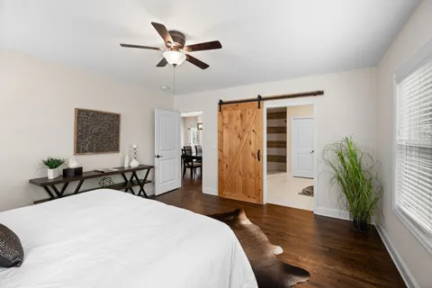 a bedroom with a bed and wooden floor
