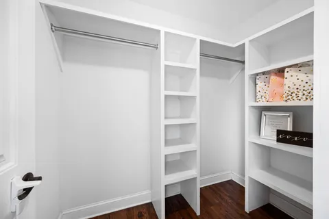 a room with walk in closet and a window