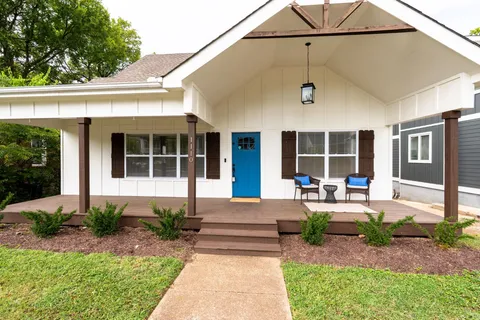 a front view of a house with garden and porch