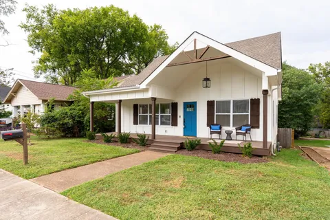 a front view of house with a garden and patio