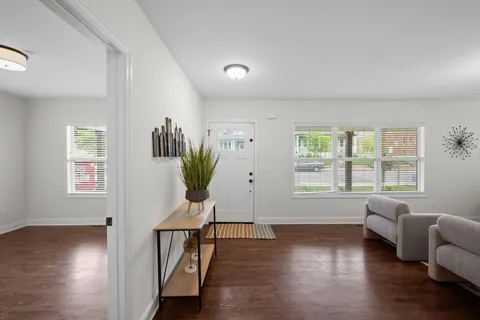 a living room with furniture window and wooden floor