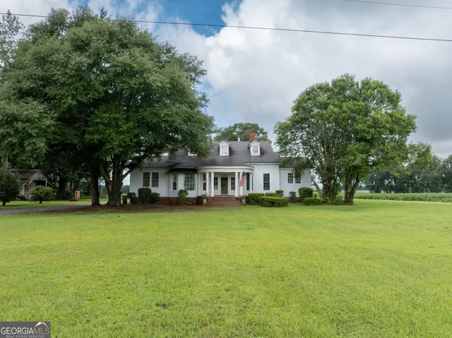 a front view of a house with a garden