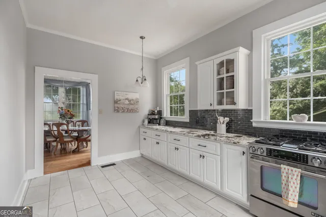a spacious bedroom with a bed a fireplace and a flat screen tv