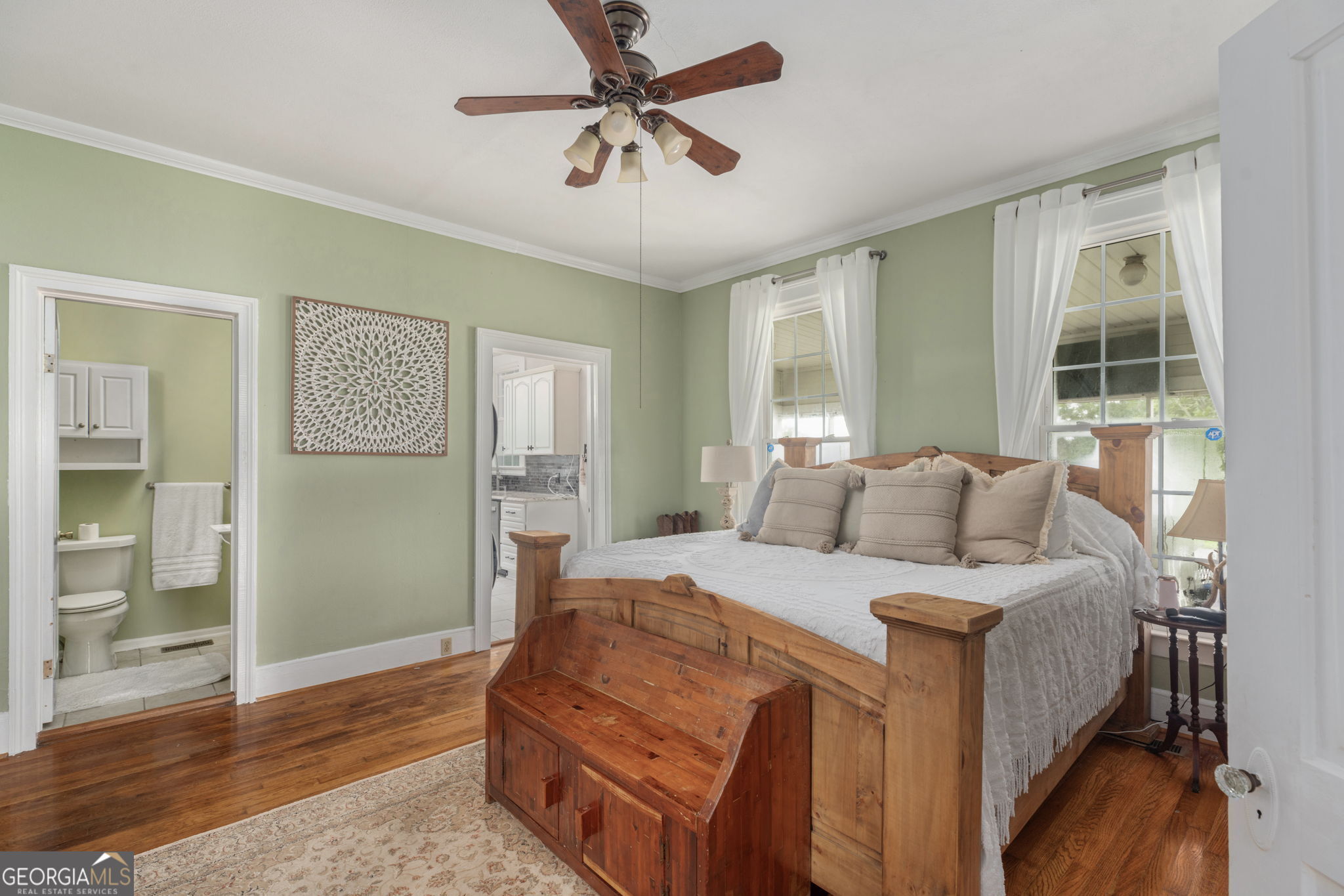 7890 Poplar Springs Road Byromville, GA 31007 - Photo 24 of 74 a bedroom with a large bed chandelier and a window